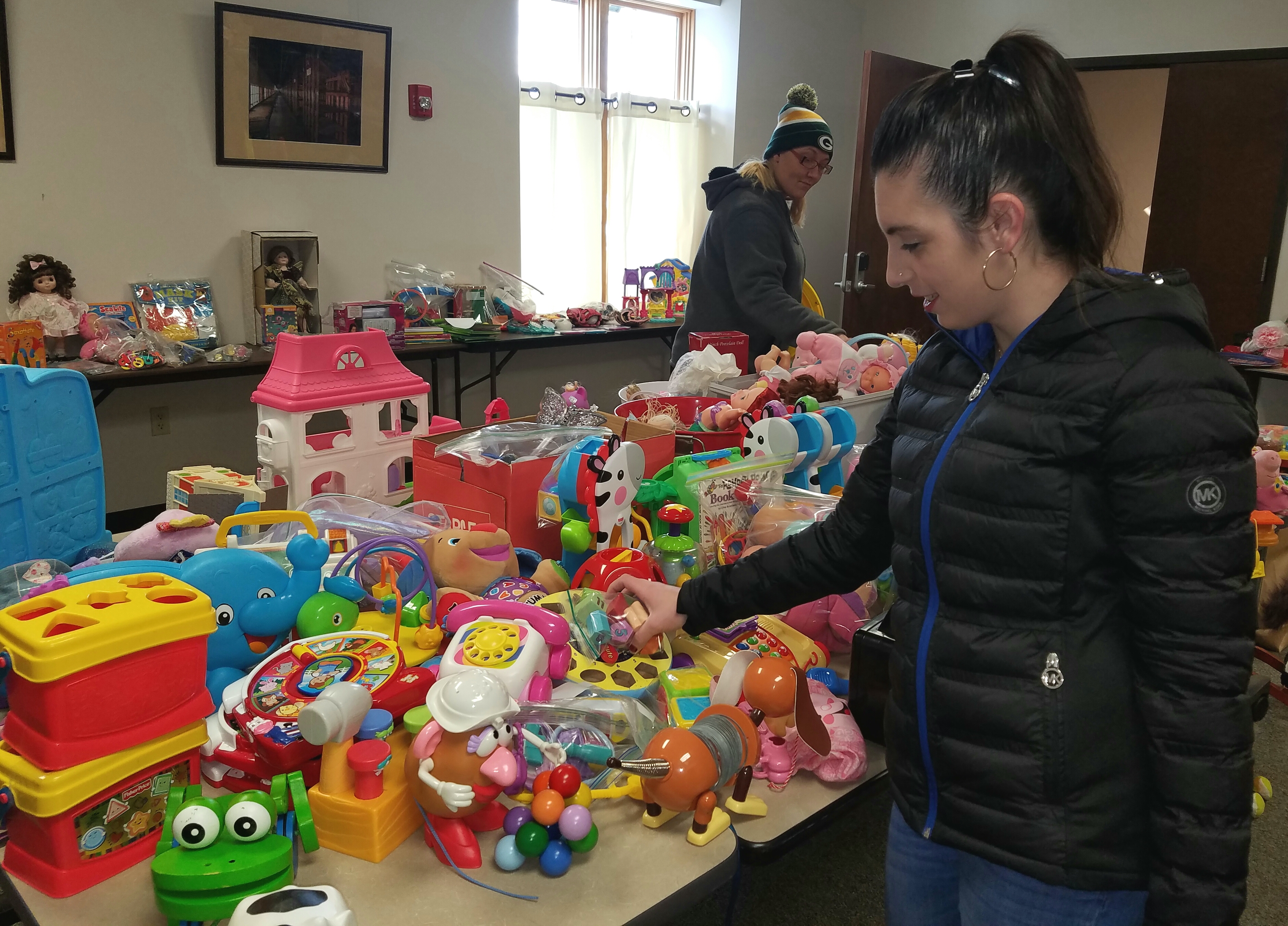Dozens of volunteers come together every December to help create Outreach’s Toyland Workshop, an opportunity for parents to select gently used toys for their children.